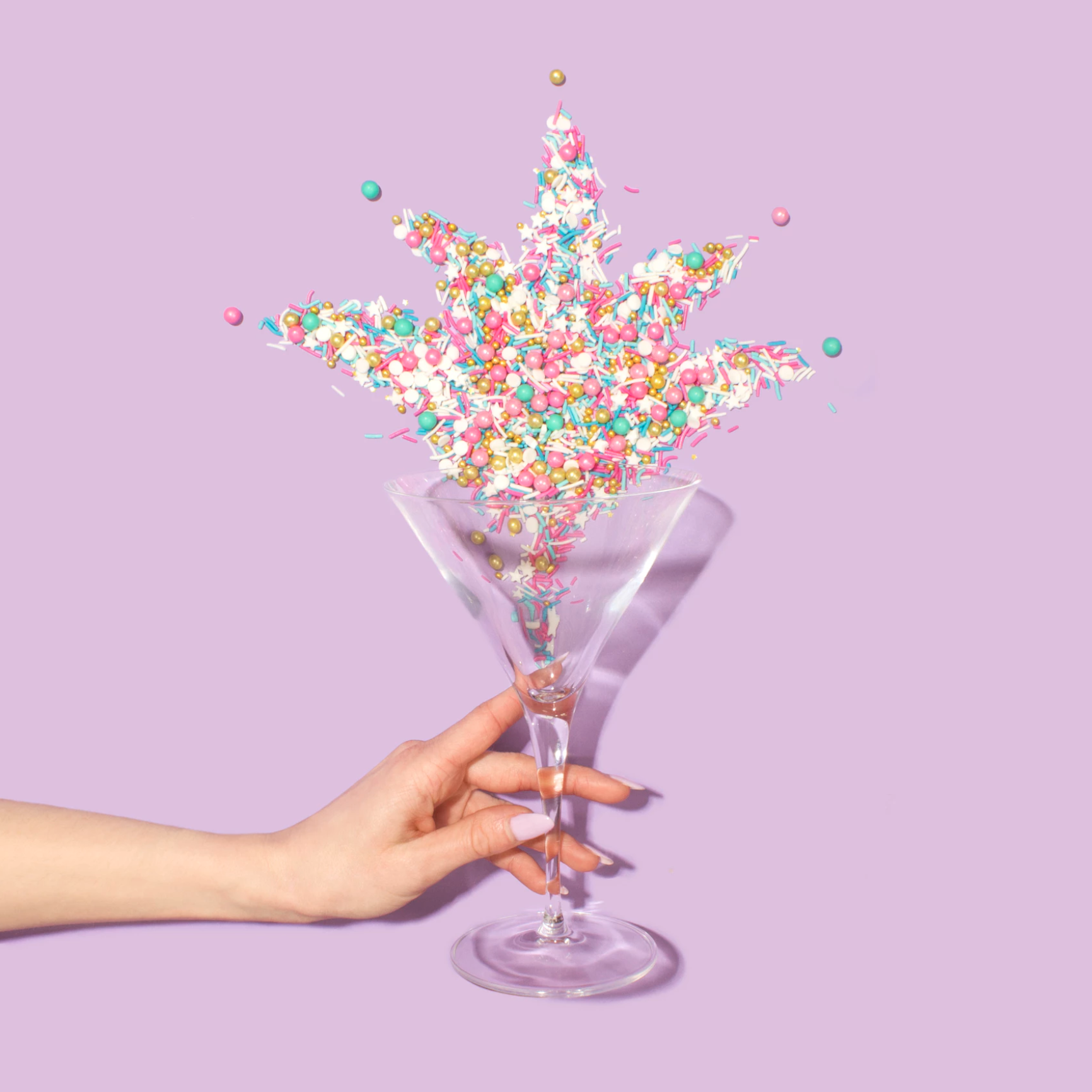 Three glasses of milk with straws holding up donuts in each glass.